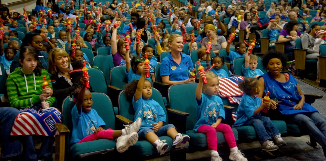 Joint Base Andrews Child Development Center children raise their free hand-held propeller toys for an audience photo prior to a USO/Sesame Street show held at the Reel Time Base Theater on May 22. The photo was later posted on the Sesame Street official website for the parents to download.  The USO and Sesame Street have made coming to Andrews an annual event. (Photo/Bobby Jones) 