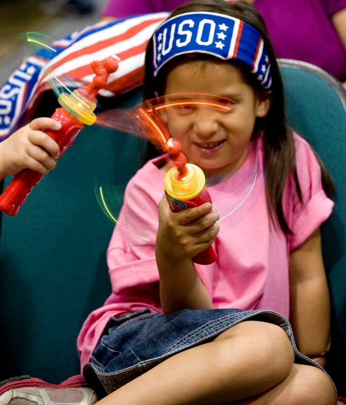 Eliyana Lopez, 5, plays with a hand-held propeller toy prior to a Sesame Street show here May 22.  Eliyana is the daughter of Staff Sgt. David Lopez, 89th Maintenance Group flying crew chief. Several Joint Base Andrews family members and the children were treated to full-cast Sesame Street shows presented by the USO and the cast of Sesame Street on May 21 and 22 at the Reel Time Base Theater. (Photo/Bobby Jones) 