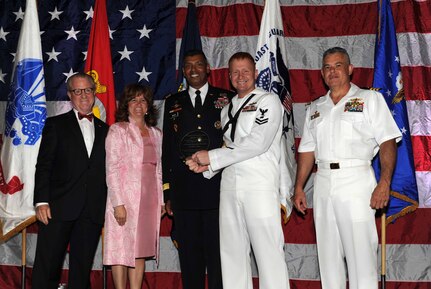 Peter Wertimer, Charleston Chamber of Military Policy council chairman, Julie Gerthoffer, Charleston Chamber of Military Relations Committee and U.S. Army Lt. Gen. Vincent Brooks, Third Army commanding general, present Petty Officer Jonathan Pitts, a Mineman and Leading Petty Officer Magazine/Field Crew, the'Enlisted Service Person of the Year' award, alongside his commanding officer, CDR Charles Phillip, Naval Munitons Command commander, during 'Salute to the Military' May 23, 2012 at the North Charleston Convention Center, S.C. This is the eighth year the Charleston Metro Chamber of Commerce recognized the local active-duty, reserve, and civilian personnel for their community service above and beyond their call of duty. (U.S. Air Force photo/Airman 1st Class Ashlee Galloway)