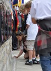 With her peers watching, a young French girl places a remembrance candle adjacent to the Troop Carrier Command Memorial June 1, 2012, in Picauville, France during a ceremony honoring U.S. Airmen and soldiers killed during the D-Day invasion. U.S. and allied forces attended the commemorative ceremony in the Picauville town square honoring the Airmen and soldiers who lost their lives when their C-47 Skytrain aircraft were brought down by German anti-aircraft artillery at 1:20 a.m., June 6, 1944 as part of the famous Normandy invasion. Members of the Air Force Reserve Command's 302nd, 910th and 440th Airlift Wings took part in this year's 68th Anniversary commemoration of the historic invasion. (U.S. Air Force photo/Staff Sgt. Stephen J. Collier)