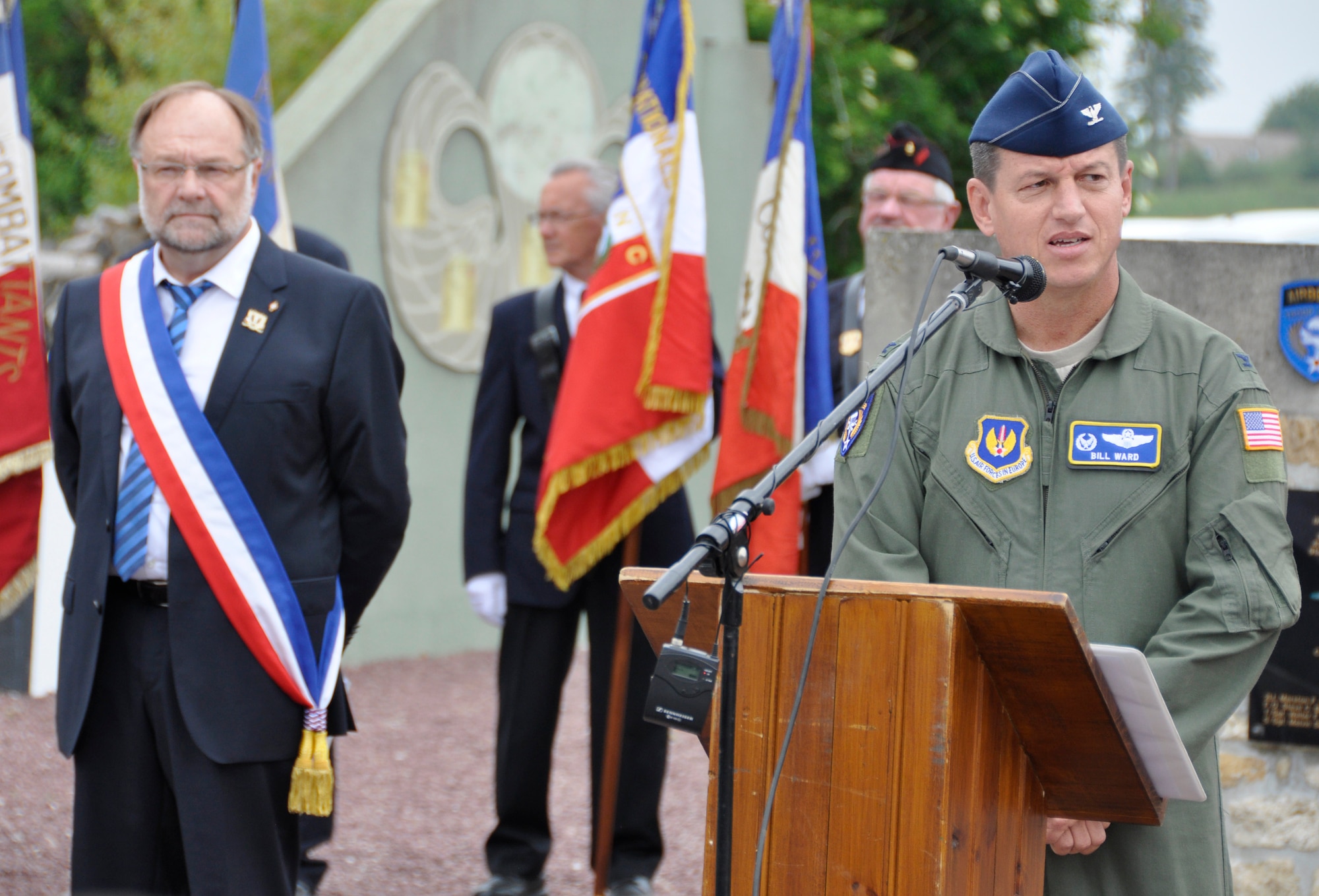 Standing adjacent to Picauville Mayor Philippe Catherine, Air Force Col. William "Bill" Ward addresses attendees June 1, 2012, during a commemorative ceremony in Picauville, France honoring the Airmen and soldiers who lost their lives during the famous Normandy D-Day invasion. U.S. and allied forces attended the ceremony in the Picauville town square that remembers the transport aircrews and paratroopers who were killed when their C-47 aircraft were brought down by German anti-aircraft artillery at 1:20 a.m., June 6, 1944 during the invasion of France. Ward is commander of the 86th Operations Group, a subordinate organization to the 86th Airlift Wing based at Ramstein Air Base, Germany. (U.S. Air Force photo/Staff Sgt. Stephen J. Collier)