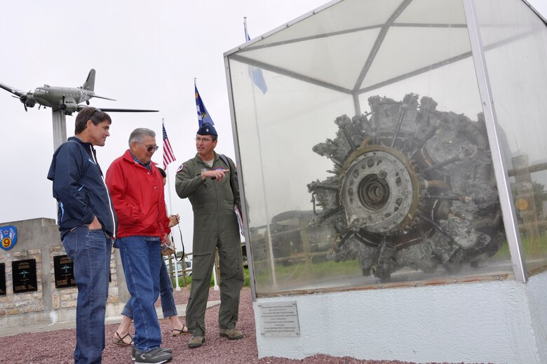 Air Force Reserve Lt. Col. Ed Strickland (center) and members of his family look over the engine of a crashed C-47 Skytrain transport June 1, 2012 in Picauville, France. U.S. and allied forces attended a commemorative ceremony in the town square honoring the Airmen and soldiers who lost their lives when their C-47 aircraft was brought down by German anti-aircraft artillery at 1:20 a.m., June 6, 1944 as part of the famous Normandy D-Day invasion of France. Strickland is a C-130 Hercules navigator assigned to the 302nd Airlift Wing at Peterson Air Force Base, Colo. Members of the Air Force Reserve Command's 302nd, 910th and 440th Airlift Wings took part in this year's 68th Anniversary commemoration of the historic invasion. (U.S. Air Force photo/Staff Sgt. Stephen J. Collier)