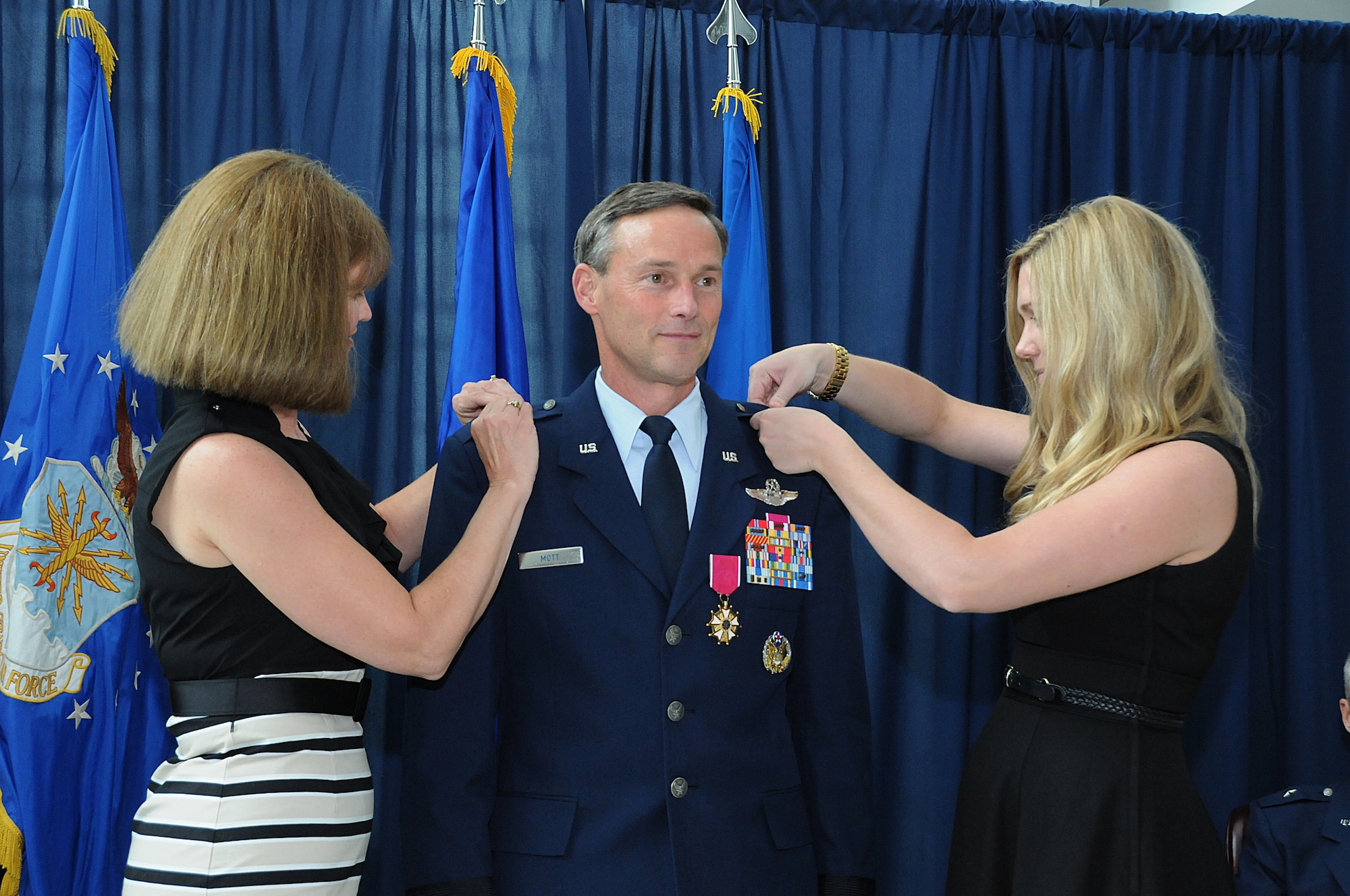 The family of Brig. Gen. Jon Mott, Special Assistant to the Air National Guard Readiness Center commander, place his new rank insignia on his uniform during his promotion ceremony to Brigadier General, May 30, 2012 at the ANGRC, Joint Base Andrews, Md. Mott was recently appointed as the next Connecticut Air Adjutant General and is scheduled to take command of the Connecticut ANG mid-July. (National Guard photo by Tech. Sgt. Melissa E. Chatham/RELEASED)