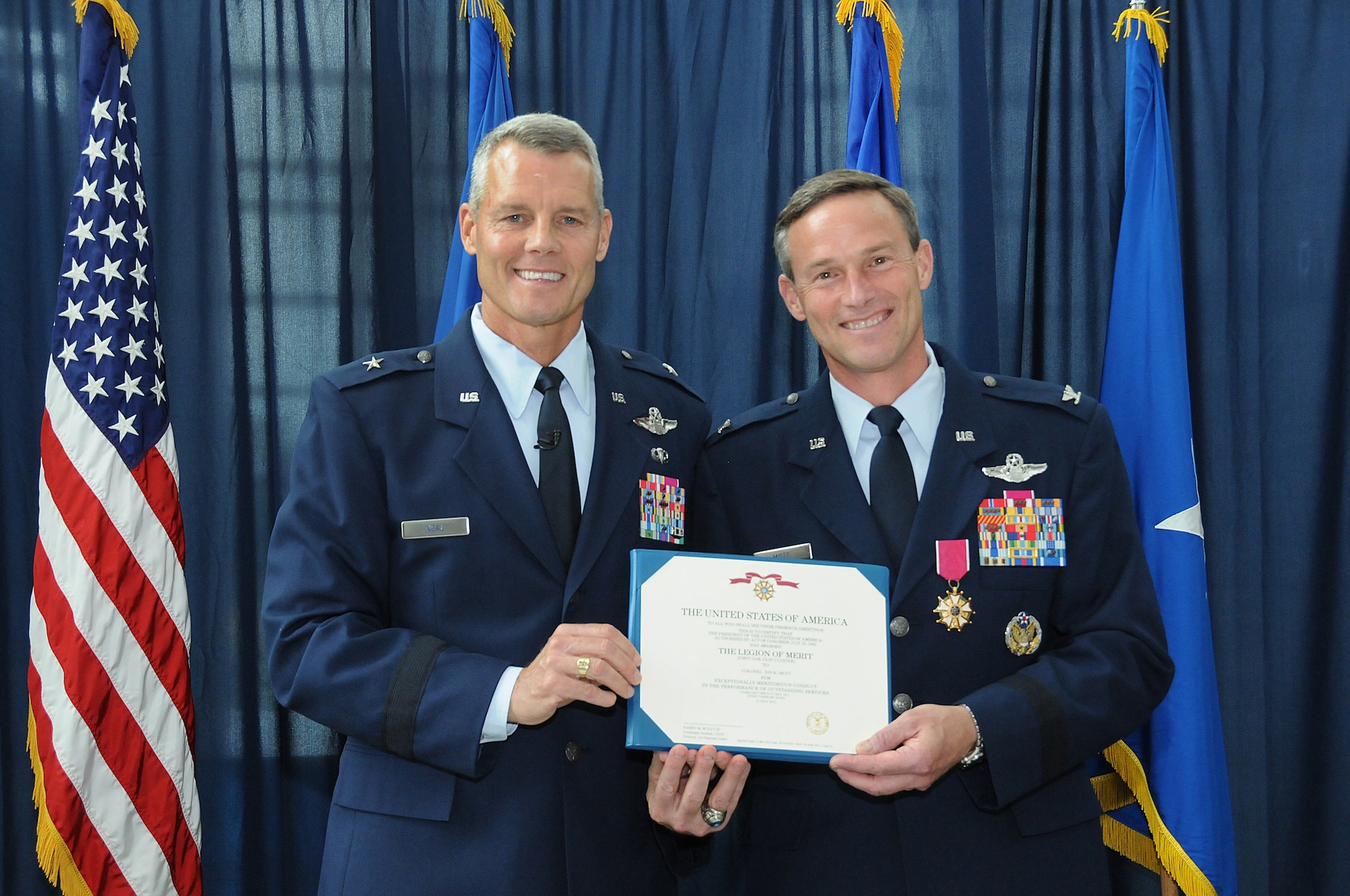 Brig. Gen. Brian Neal, Air National Guard Readiness Center Commander presents the Legion of Merit to Brig. Gen. Jon Mott, Special Assistant to the ANGRC commander, during Mott's promotion ceremony to Brigadier General, May 30, 2012 at the ANGRC, Joint Base Andrews, Md. Mott was recently appointed as the next Connecticut Air Adjutant General and is scheduled to take command of the Connecticut ANG mid-July. (National Guard photo by Tech. Sgt. Melissa E. Chatham/RELEASED)