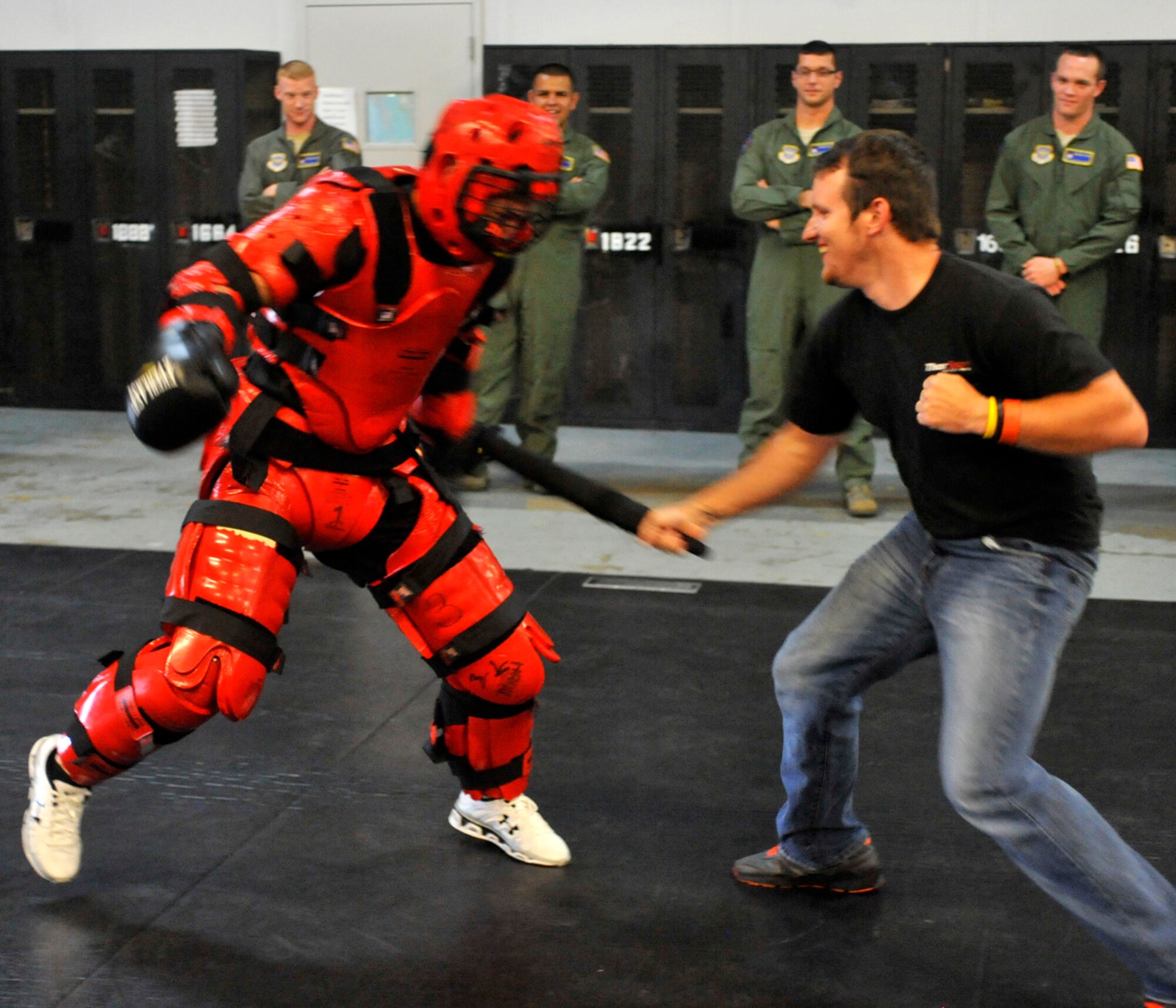 Devon Armstrong, crew member for driver Dakota Armstrong's Camping World Truck Series number 98 truck, spars with the "red man" at the 436th Security Forces Squadron Ravens training area May 30, 2012, on Dover Air Force Base, Del. Armstrong and other crew members got a self-defense demonstration from the Ravens during a tour of the base. (U.S. Air Force photo by Tech. Sgt. Chuck Walker)