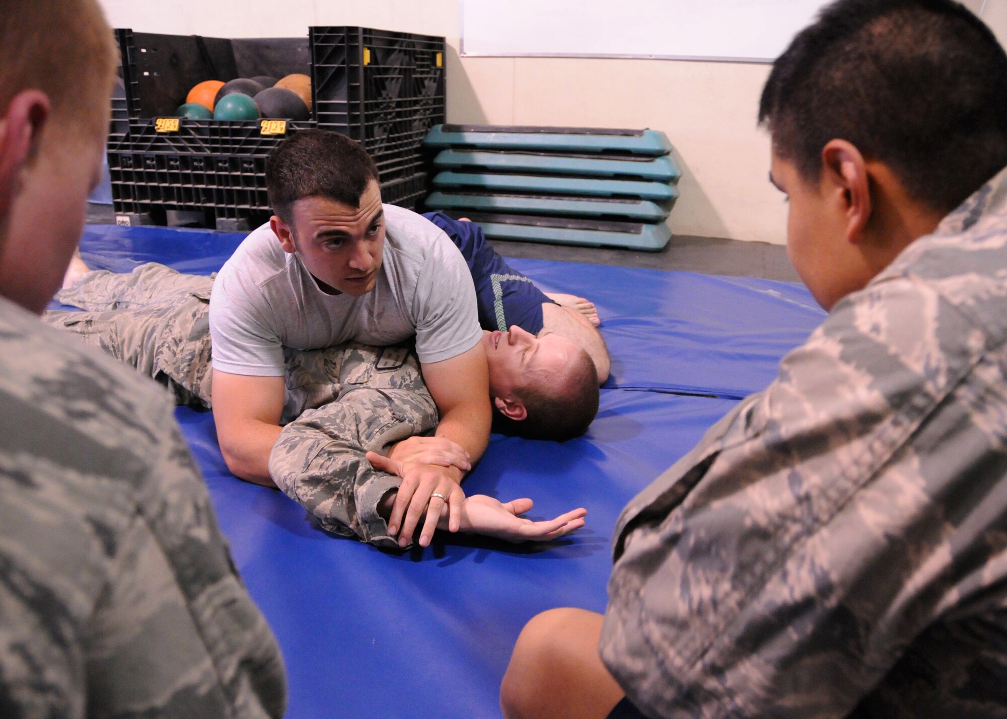 Staff Sgt. Timothy Ethridge, a 73rd Expeditionary Air Control Squadron aerospace ground equipment supervisor, teaches his Jiu Jitsu class members the Americana technique, a shoulder joint lock, here at the Freedom Gym at Kandahar Airfield, Afghanistan, May 29, 2012. The Jiu Jitsu class improves the core and relieves stress. Jiu Jitsu concentrates on some stand-up moves but mostly centers on taking the opponent to the ground. (U.S. Air Force photo/Staff Sgt. Heather Skinkle)