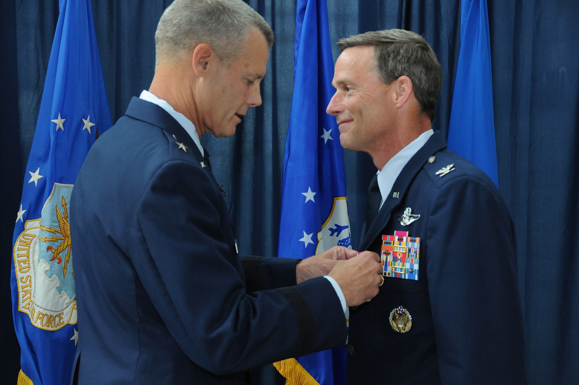 Brig. Gen. Brian Neal, Air National Guard Readiness Center Commander presents the Legion of Merit to Brig. Gen. Jon Mott, Special Assistant to the ANGRC commander, during Mott's promotion ceremony to Brigadier General, May 30, 2012 at the ANGRC, Joint Base Andrews, Md. Mott was recently appointed as the next Connecticut Air Adjutant General and is scheduled to take command of the Connecticut ANG mid-July. (National Guard photo by Tech. Sgt. Melissa E. Chatham/RELEASED)