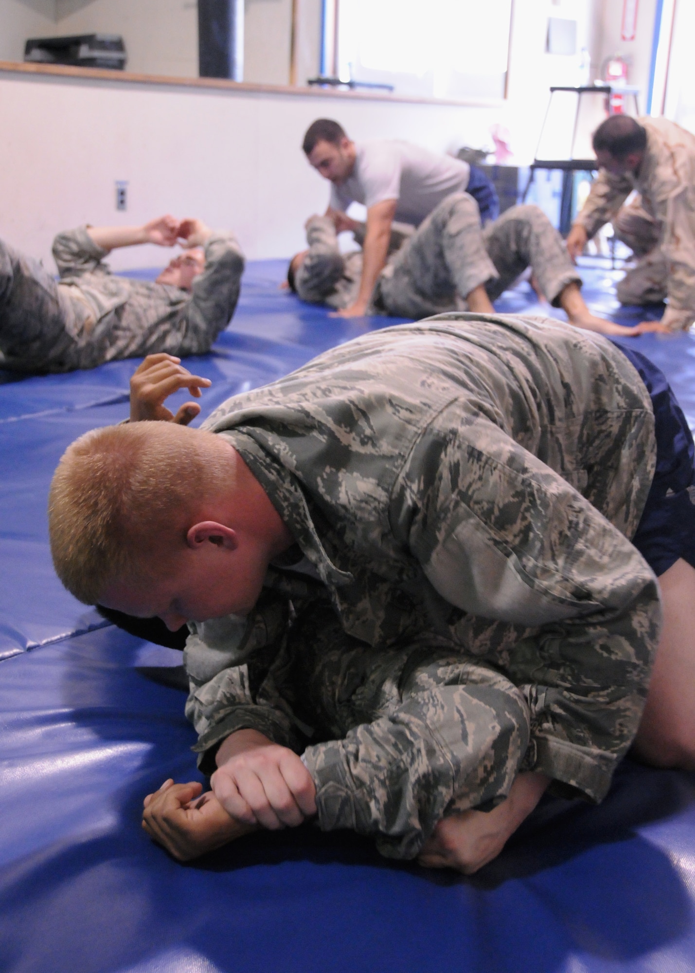 Airman 1st Class Collin Gronning with the 73rd Expeditionary Air Control Squadron pins a sparring partner here at the Freedom Gym at Kandahar Airfield, Afghanistan, May 29, 2012. Gronning and several others learn Jiu Jitsu from Staff Sgt. Timothy Ethridge, a 73rd Expeditionary Air Control Squadron aerospace ground equipment supervisor. The class concentrates on some stand-up moves but mostly centers on taking the opponent to the ground. (U.S. Air Force photo/Staff Sgt. Heather Skinkle)