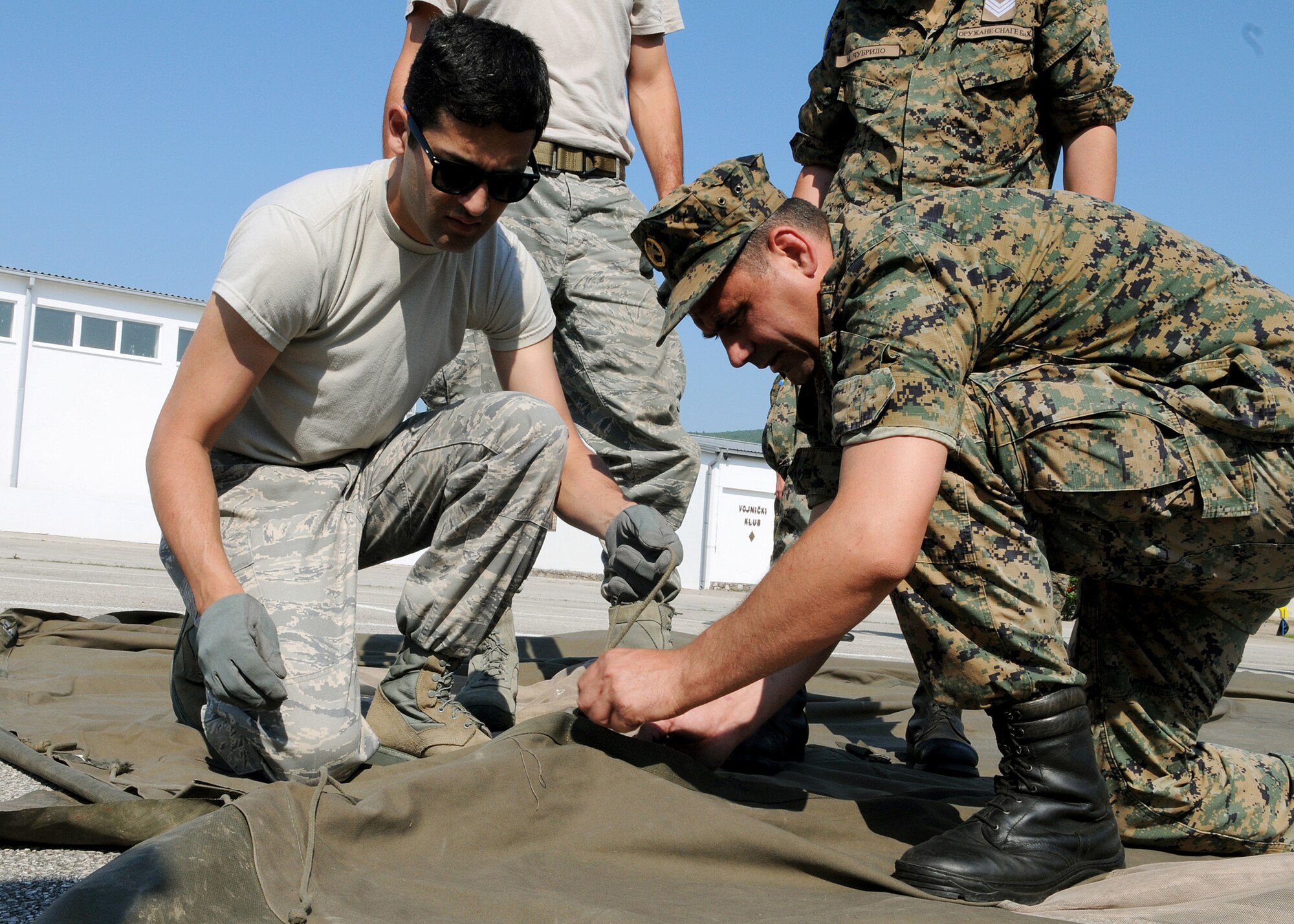 CAPLJINA, Bosnia and Herzegovina -- Participants of Shared Resilience 2012 set up a Bosnian-Herzegovinian military tent during the Expeditionary Medical Support course here May 31, 2012. More than 500 military members from nine nations are participating in SR12, an annual U.S. Joint Chiefs of Staff sponsored exercise, May 28 - June 8. The goals of the exercise are to strengthen interoperability, facilitate training in crisis response and disaster management, and validate the readiness of deployable military medical and humanitarian assistance teams. The exercise, in the spirit of partnership for peace, directly supports U.S. European Command's theater cooperation efforts and strategy for active security with European countries.