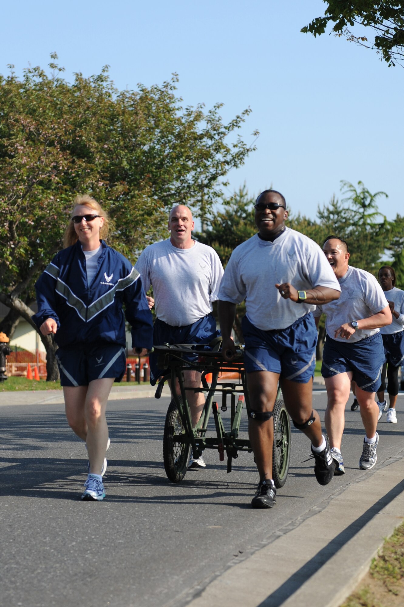 Members of the 35th Medical Group push a medical litter to show unit pride during a readiness run at Misawa Air Base, Japan, June 1, 2012. Readiness runs encourage fitness and boost morale throughout participating units. (U.S. Air Force photo by Airman 1st Class Kia Atkins/Released)
