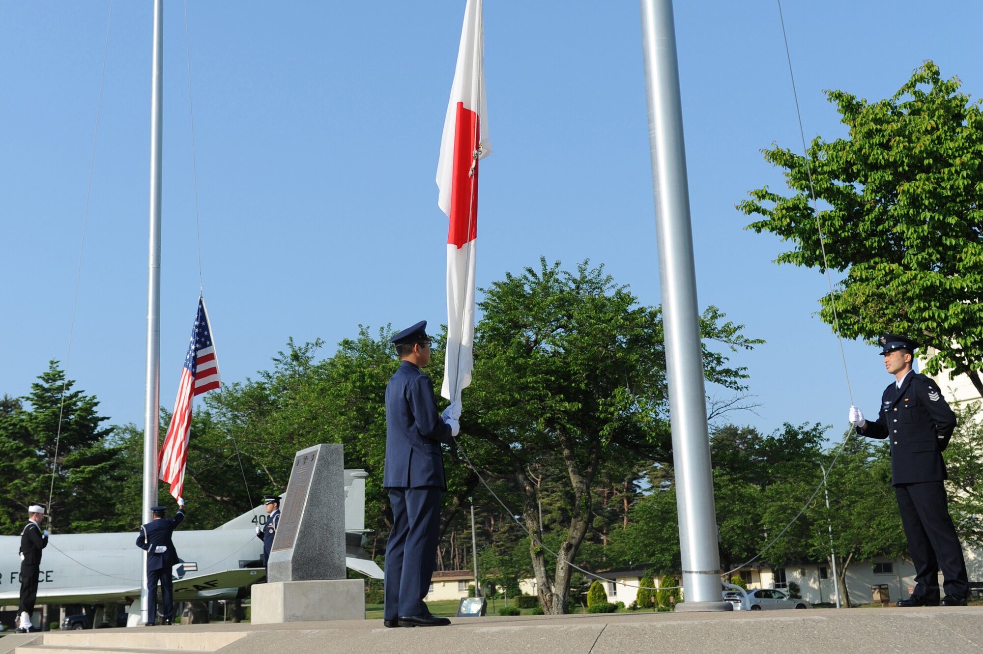 U.S. Air Force Honor Guard and Japan Air Self-Defense Force members raise the flags before the first readiness run of the year at Misawa Air Base, Japan, June 1, 2012. The readiness run was hosted by Naval Air Facility Misawa with help from the NAF First Class Petty Officers Association. (U.S. Air Force photo by Airman 1st Class Kia Atkins/Released)