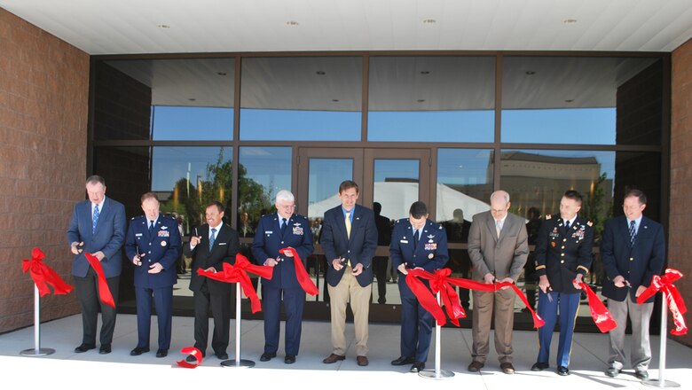 Included in the ribbon-cutting (L to R): Mr. Donald Greenwood, president of construction, Burns & McDonnell Corporation; Lt. Col. David Hornyak, vice commander, 377th Air Base Wing; Mr. John Garcia, chairman of the Kirtland Partnership Committee; Col. Daniel Morin, vice commander, Air Force Research Lab; U.S. Representative Martin Heinrich; Col. William Cooley, director, Space Vehicles; Dr. Joel Mozer, associate chief, Battlespace Environment Division; Lt. Col. Jason Williams, Albuquerque District Commander, U.S. Army Corps of Engineers; Mr. Brent Wilson, base civil engineer, Kirtland Air Force Base.