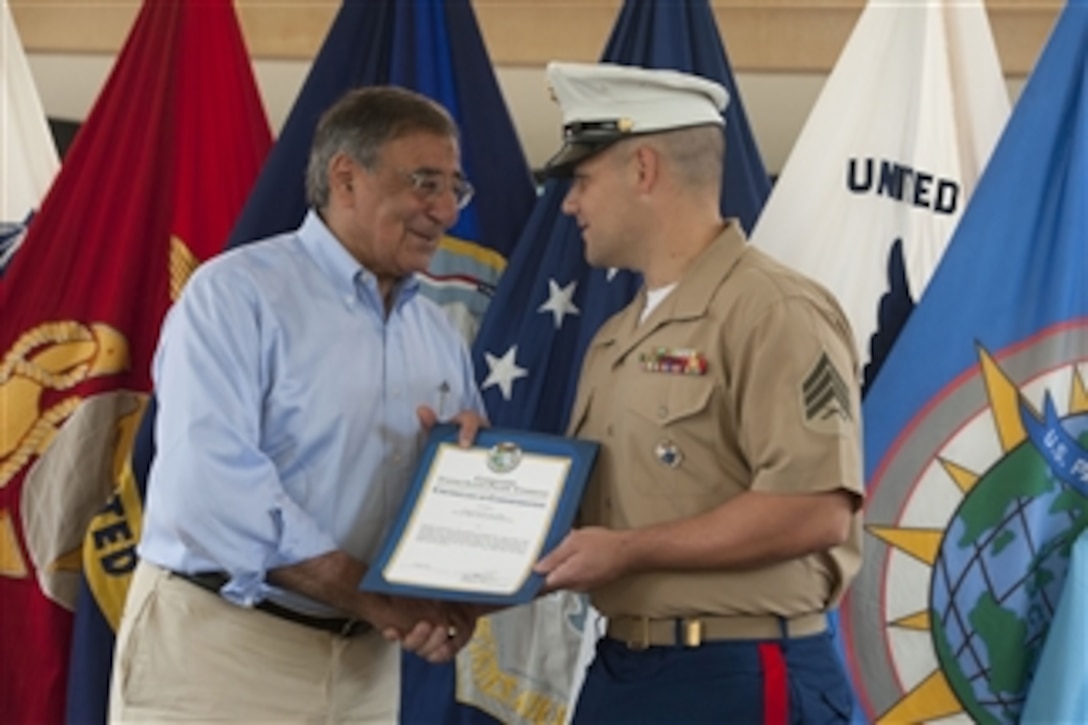 Secretary of Defense Leon E. Panetta presents Sgt. David Long, U.S. Marine Corps, a certificate of commendation during a visit to the United States Pacific Command at Camp H.M. Smith, Hawaii, on May 31, 2012.  Panetta presented awards to three service members and one civilian employee and spoke to the audience at the recognition ceremony.  Panetta is on a ten-day trip to the Asia-Pacific to meet with defense counterparts.  