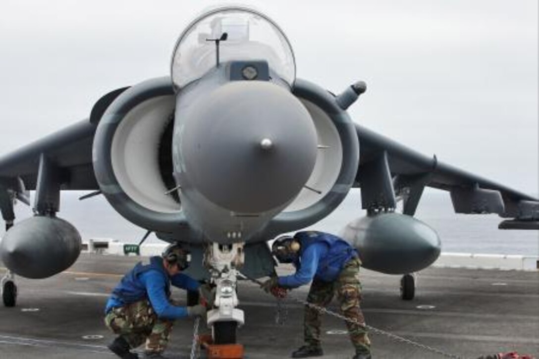 Sailors secure an AV-8B Harrier to the flight deck of the USS Peleliu before refueling the aircraft during daily flight operations as part of PHIBRON Three and 15th MEU’s PHIBRON-MEU Interoperability Training off the coast of southern California, June 1. The purpose of the exercise is to give Marines and sailors the opportunity to become familiar working together as a blue-green team, a must when it comes to flight deck operations.::r::::n::::r::::n::::r::::n::