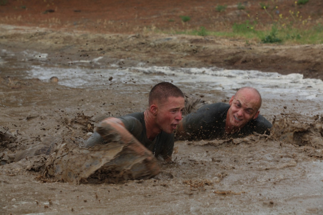 Camp Pendleton Marines low crawl through a mud pit as they participate in the challenge of the 2012 Hard Corps Race Series World Famous Mud Run near lake O’Neil, June 1. The Mud Run is a challenging 10K run with hills, tire obstacles, river crossings, two 5-foot walls with mud on both sides, tunnel crawl, slippery hill climb, and the final 30-foot mud pit.::r::::n::::r::::n::