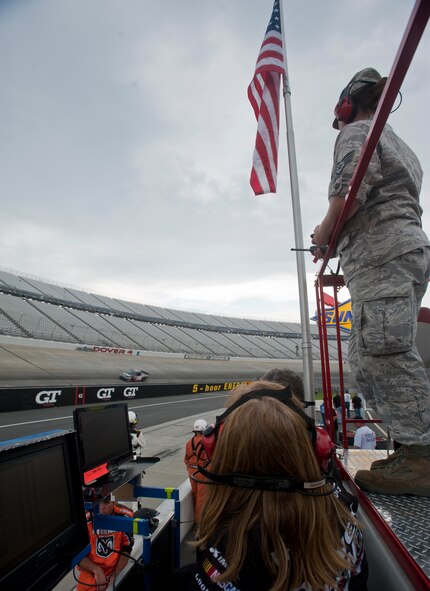 Staff Sgt. Tiffany Sauler watches Jennifer Jo Cobb’s Driven 2 Honor Camping World Truck Series No. 10 truck as it completes a lap during the Lucas Oil 200 June 1, 2012, at Dover International Speedway, Del. Cobb created Driven 2 Honor in order to honor America’s military women. (U.S. Air Force photo by Senior Airman Jacob Morgan)