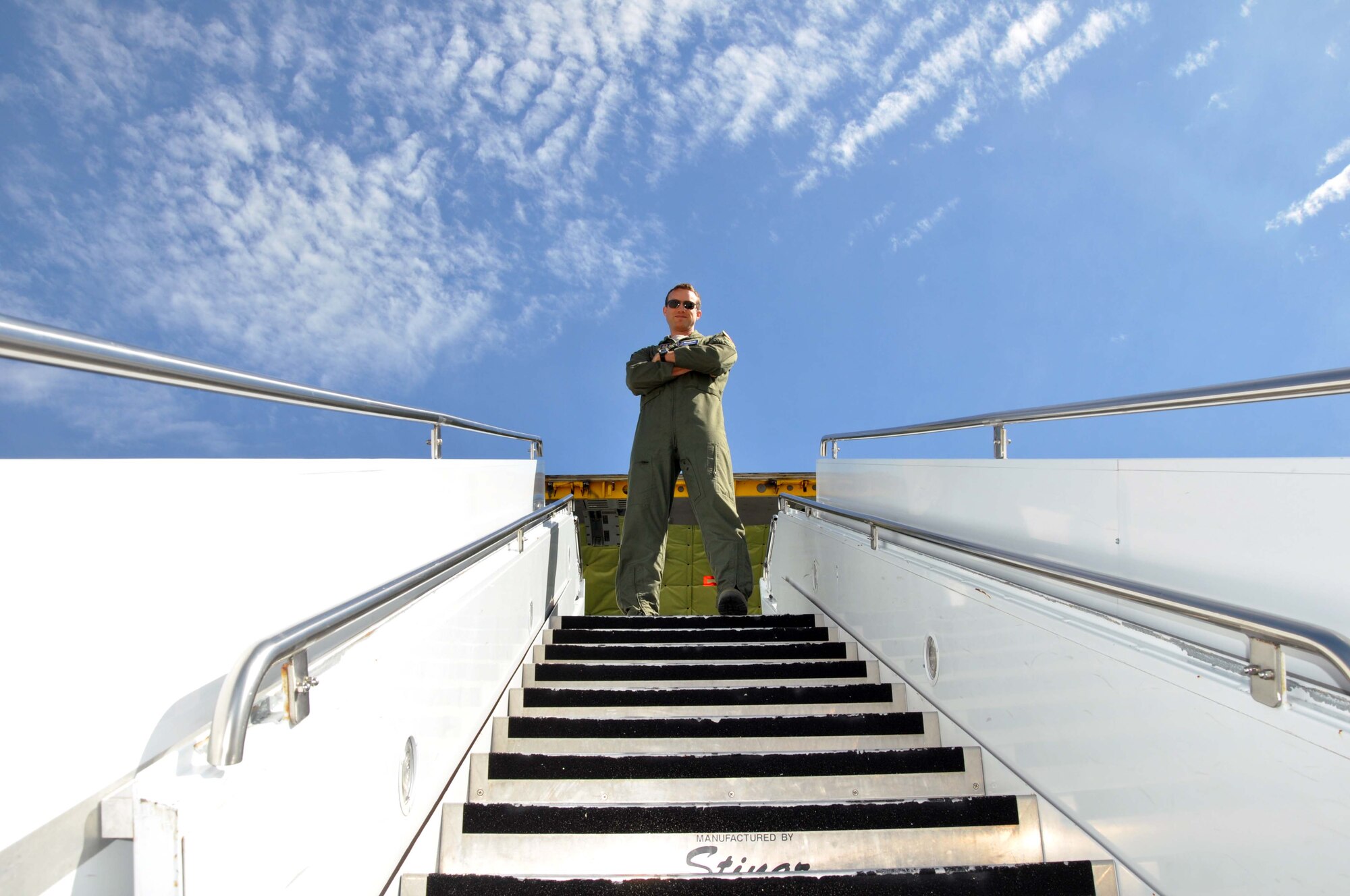 Capt. Chris Kidd, a pilot assigned to the 18th Air Refueling Squadron, 931st Air Refueling Group, McConnell Air Force Base, Kan., stands atop a stair truck at the entrance of a KC-135 Stratotanker, McConnell Air Force Base, Kan., June 2, 2012.  Kidd had presented a mission brief to a group of 931st Air Refueling Group spouses prior to a spouse orientation flight and assisted in escorting the spouses onto the aircraft.  (U.S. Air Force photo by 1st Lt. Zach Anderson)