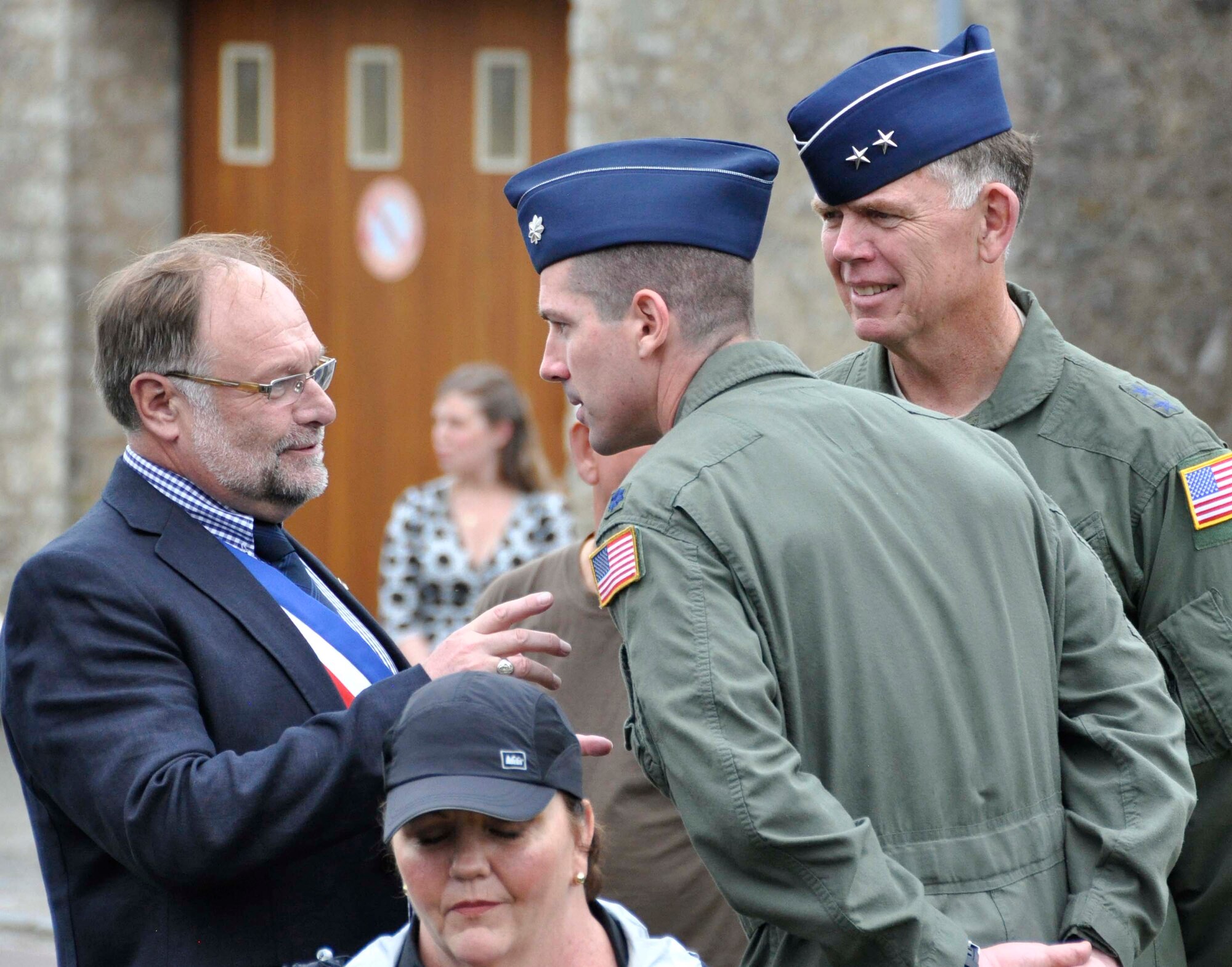 Philippe Catherine (left), mayor of Picauville, France, speaks June 1, 2012, with Air Force Reserve Maj. Gen. Wallace W. "Wade" Farris Jr. (right) and Lt. Col. John Lacy, assistant U.S. air attache to France with the Defense Attache Office in Paris, after the Airmen presented wreaths to a memorial dedicated to fallen World War II U.S. aircrews and paratroopers in Picauville, France. U.S. Soldiers and Airmen, together with British paratroopers, took part in the ceremonial event commemorating the 68th Anniversary of the Normandy D-Day invasion. Later, U.S. and British forces dined with members of the Picauville community where they honored the village for their continued remembrance of the Allied invasion forces. Farris is the 22nd Air Force commander, an Air Force Reserve organization. (U.S. Air Force photo/Staff Sgt. Stephen J. Collier)