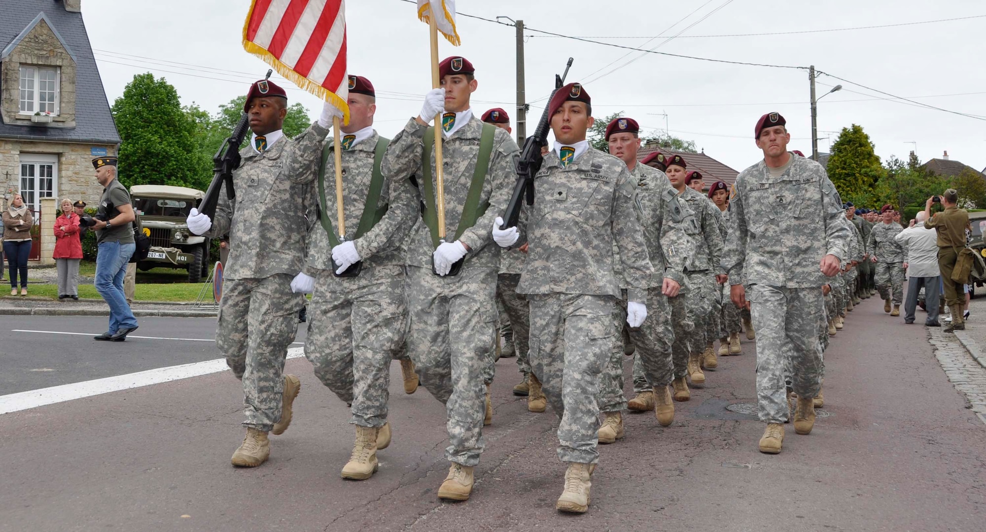 U.S. Soldiers and Airmen, together with British paratroopers, march in formation June 1, 2012 through Picauville, France as part of ceremonial events commemorating the 68th Anniversary of the Normandy D-Day invasion. The U.S. military members, led by Air Force Reserve Maj. Gen. Wallace W. "Wade" Farris Jr., laid a wreath in honor of fallen aircrews and paratroopers who perished during the invasion of France. Later, U.S. and British forces dined with members of the Picauville community where they honored the village for their continued remembrance of the Allied invasion forces. Farris is the 22nd Air Force commander, an Air Force Reserve organization. (U.S. Air Force photo/Staff Sgt. Stephen J. Collier)