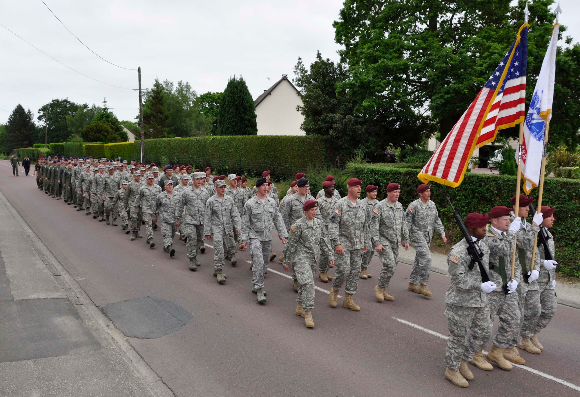 U.S. Soldiers and Airmen, together with British paratroopers, march in formation June 1, 2012 through Picauville, France as part of ceremonial events commemorating the 68th Anniversary of the Normandy D-Day invasion. The U.S. military members, led by Maj. Gen. Wallace W. "Wade" Farris Jr., laid a wreath in honor of fallen aircrews and paratroopers who perished during the invasion of France. Later, U.S. and British forces dined with members of the Picauville community where they honored the village for their continued remembrance of the Allied invasion forces. Farris is the 22nd Air Force commander, an Air Force Reserve organization. (U.S. Air Force photo/Staff Sgt. Stephen J. Collier)