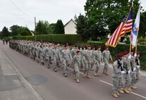 U.S. Soldiers and Airmen, together with British paratroopers, march in formation June 1, 2012 through Picauville, France as part of ceremonial events commemorating the 68th Anniversary of the Normandy D-Day invasion. The U.S. military members, led by Maj. Gen. Wallace W. "Wade" Farris Jr., laid a wreath in honor of fallen aircrews and paratroopers who perished during the invasion of France. Later, U.S. and British forces dined with members of the Picauville community where they honored the village for their continued remembrance of the Allied invasion forces. Farris is the 22nd Air Force commander, an Air Force Reserve organization. (U.S. Air Force photo/Staff Sgt. Stephen J. Collier)