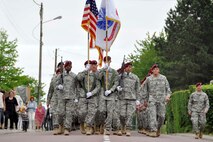 U.S. Soldiers and Airmen, together with British paratroopers, march in formation June 1, 2012 through Picauville, France as part of ceremonial events commemorating the 68th Anniversary of the Normandy D-Day invasion. The U.S. military members, led by Air Force Reserve Maj. Gen. Wallace W. "Wade" Farris Jr., laid a wreath in honor of fallen aircrews and paratroopers who perished during the invasion of France. Later, U.S. and British forces dined with members of the Picauville community where they honored the village for their continued remembrance of the Allied invasion forces. Farris is the 22nd Air Force commander, an Air Force Reserve organization. (U.S. Air Force photo/Staff Sgt. Stephen J. Collier)