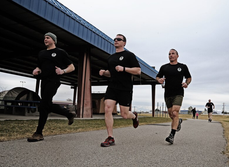 Maj. Shawn Scott, Tech. Sgt. Mark Andrews and Lt. Col. Tom Shuler from the 124th Air Support Operations Squadron of the Idaho Air National Guard run laps around the Gowen Field running track March 17. Beginning at 5 p.m. March 17 and lasting until 5 p.m. the following day, more than 30 Idaho ASOS members ran 270 miles to honor three ASOS Airmen who were killed in action during the month of March, including Maj. Greg Stone, a former Air Liaison Officer from the 124th ASOS who died March 25, 2003, in Kuwait. The 124th was one of several units from around the world to participate in the inaugural event.