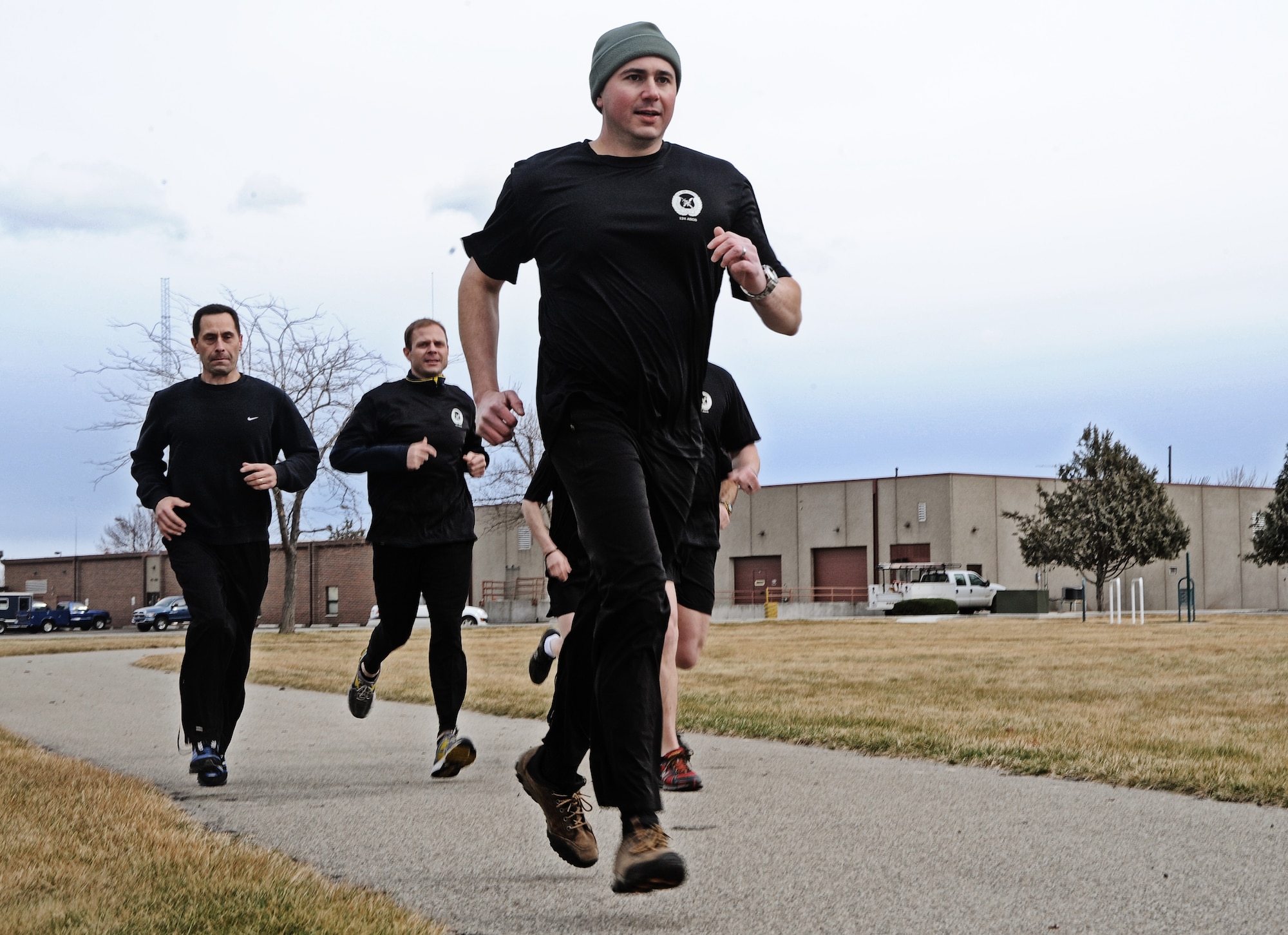Maj. Shawn Scott, Air Liaison officer, and other members of the 124th Air Support Operations Squadron of the Idaho Air National Guard run laps around the Gowen Field running track March 17. Beginning at 5 p.m. March 17 and lasting until 5 p.m. the following day, more than 30 Idaho ASOS members ran 270 miles to honor three ASOS airmen who were killed in action during the month of March, including Maj. Greg Stone, a former Air Liaison Officer from the 124 ASOS who died March 25, 2003, in Kuwait. The 124th was one of several units from around the world to participate in the inaugural event.