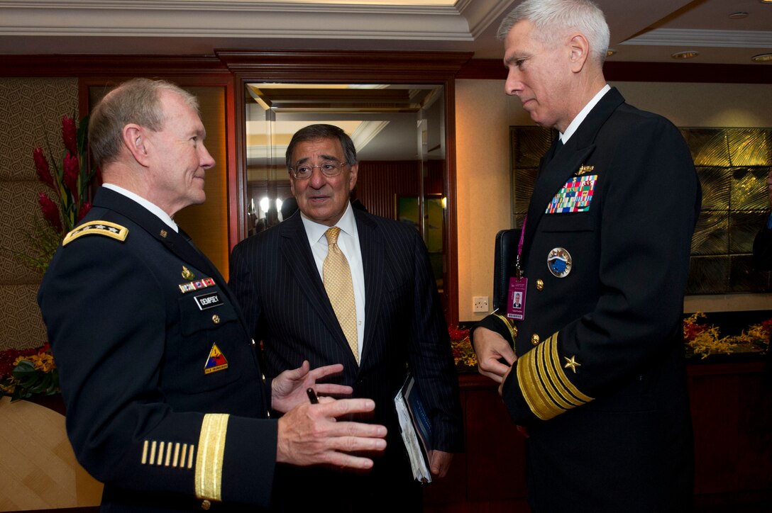U.S. Defense Secretary Leon E. Panetta speaks with U.S. Army Gen. Martin Dempsey, left, chairman of the Joint Chiefs of Staff, and U.S. Navy Adm. Samuel J. Locklear III, commander of U.S. Pacific Command, at the Shangri-La Dialogue in Singapore, June 2, 2012.