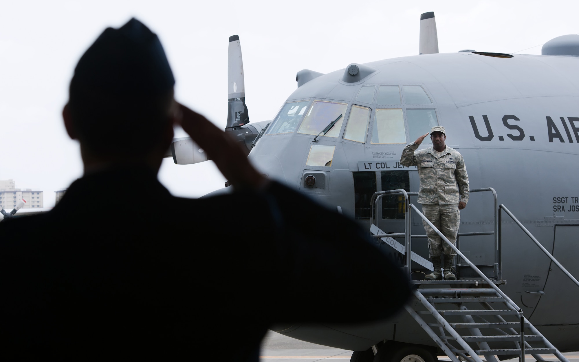 YOKOTA AIR BASE, Japan -- Staff Sgt. Shaun Stallworth, 374th Aircraft Maintenance Squadron crew chief, right, presents the 36th Airlift Squadron commander's aircraft to Lt. Col. Jeffrey Menasco, left, during the 36th AS change of command ceremony at Yokota Air Base, Japan, on June 1, 2012. (U.S. Air Force photo by Osakabe Yasuo) 