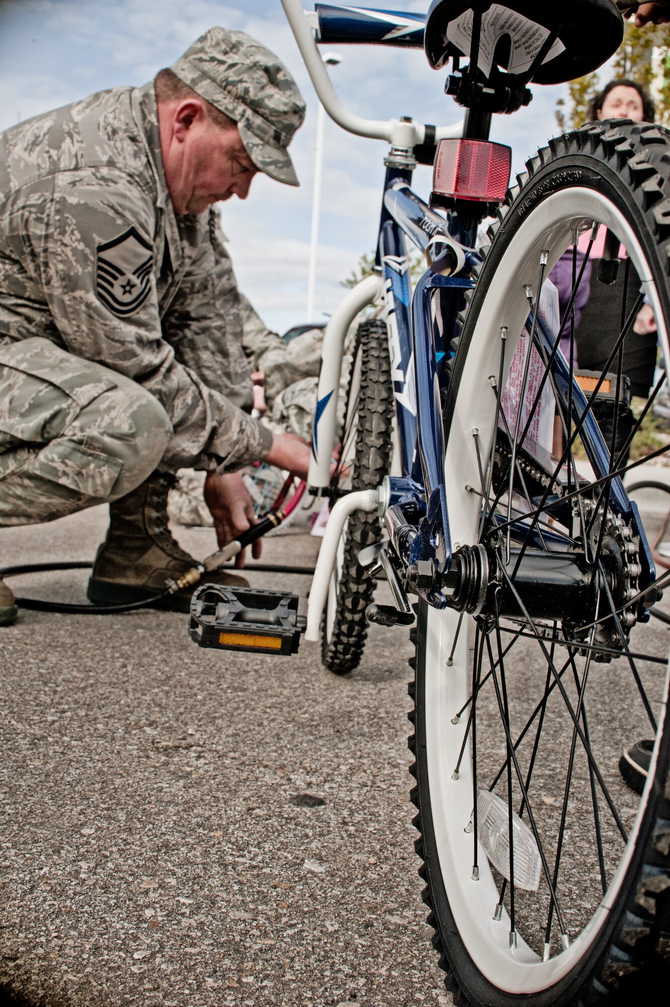 Master Sgt. Neil Ramey, 124th Logistics Readiness Squadron, readies a bike for its new owner as part of Burgers for Bikes, Bikes for Kids giveaway event, May 5, at Applebee's Restaurant on Vista Avenue in Boise. For 20 years, Idaho Air National Guard volunteers have transported and provided on-site repairs and adjustments to more than 5,250 bikes for deserving youth who are nominated through local schools. (Air Force photo by Tech. Sgt. Becky Vanshur)