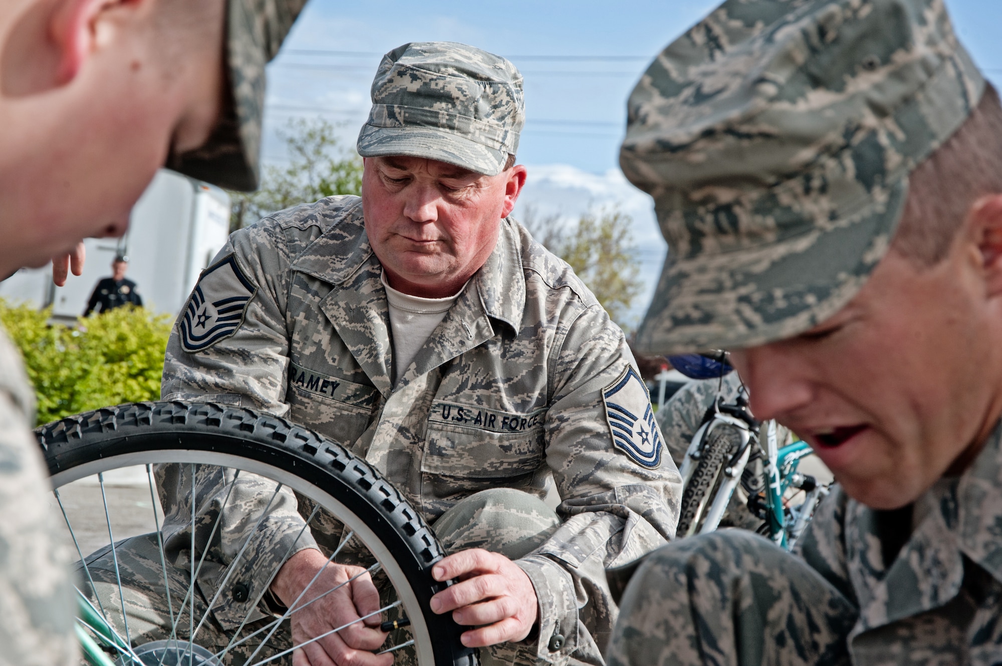 Master Sgt. Neil Ramey, 124th Logistics Readiness Squadron, readies a bike for its new owner alongside Senior Airmen Christiopher Vogl (left) and Christopher Christman as part of the Burgers for Bikes, Bikes for Kids giveaway event May 5 at Applebee's Restaurant on Vista Avenue in Boise. For 20 years, Idaho Air National Guard volunteers have transported and provided on-site repairs and adjustments to more than 5,250 bikes for deserving youth who are nominated through local schools. (Air Force photo by Tech. Sgt. Becky Vanshur)