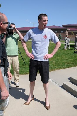 Tech. Sgt. Joshua Zimmerly from the Gowen Field Fire Department strikes a pose in his new shoes at the Walk a Mile in Her Shoes event April 20 at Gowen Field, Boise, Idaho. The event was held in recognition of Sexual Assault Awareness month. (Air Force photo by Master Sgt. Tom Gloekle)