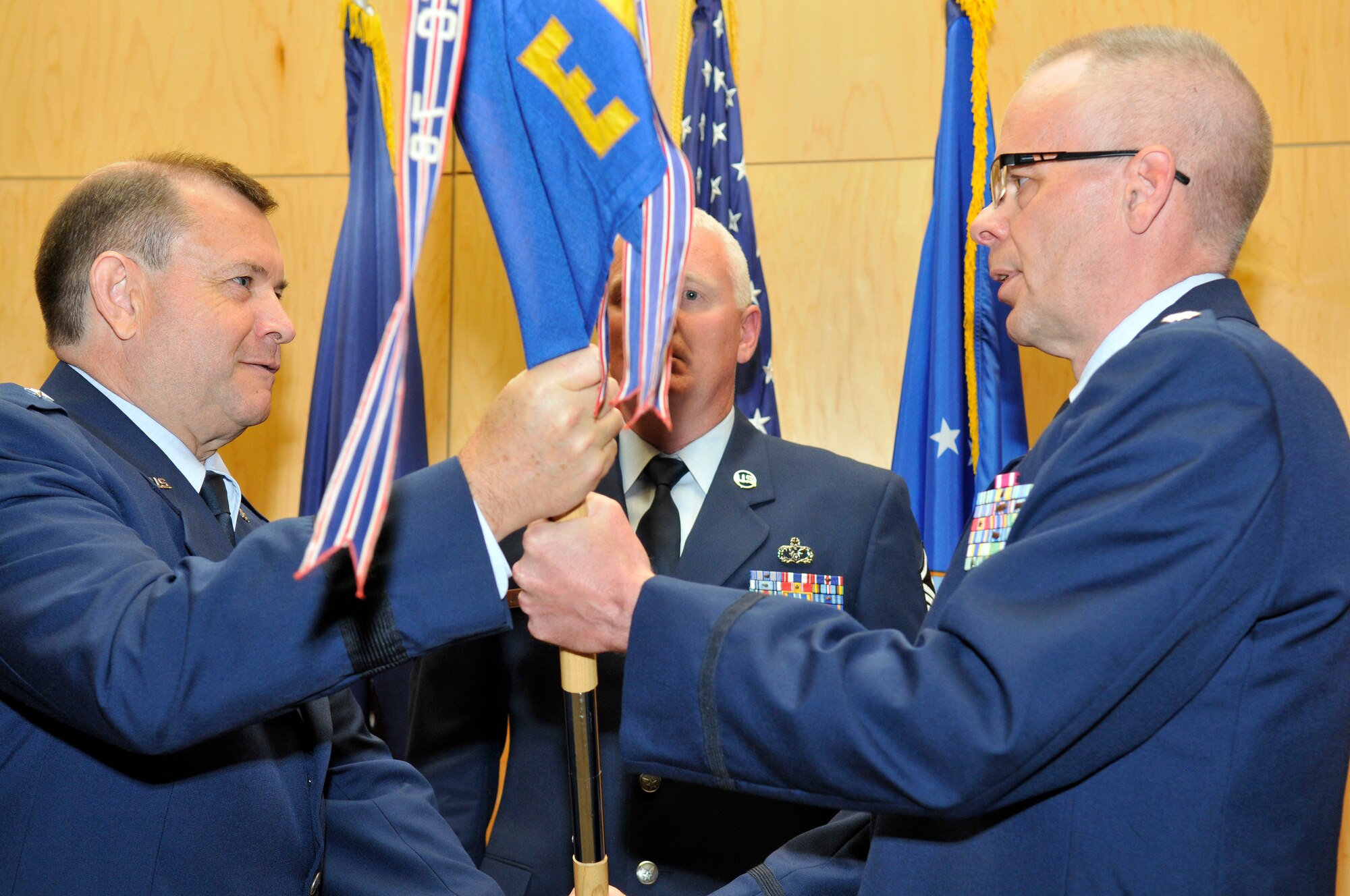 Brig. Gen. David Fountain hands the 130th Engineering Installation Squadron Guidon to Lt. Col. Kevin Tobias during the change of command ceremonyfor the 130th. Lt. Col. Tobias took command of the 130th at the Utah Air National Guard Base in Salt Lake City Utah on June 2 2012. (U.S. Air Force Photo by Tech. Sgt. Jeremy Giacoletto-Stegall/Released)