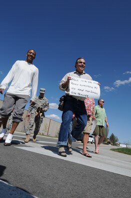 Retired Chief Master Sgt. Terry Williams, Joint Force Headquarters Sexual Assault Prevention and Response Office, and other members of the Idaho National Guard don women's shoes for the Walk a Mile in Her Shoes event April 20 at Gowen Field, Boise, Idaho. The event was held in recognition of Sexual Assault Awareness month.