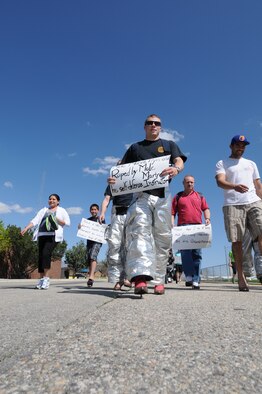Members of the Idaho National Guard don women's shoes for the Walk a Mile in Her Shoes event April 20 at Gowen Field, Boise, Idaho. The event was held in recognition of Sexual Assault Awareness month.