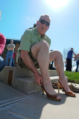 Senior Master Sgt. Steve White of the 124th Medical Group tries on his new footware in preparation for the Walk a Mile in Her Shoes event April 20 at Gowen Field, Boise, Idaho. The event was held in recognition of Sexual Assault Awareness month.