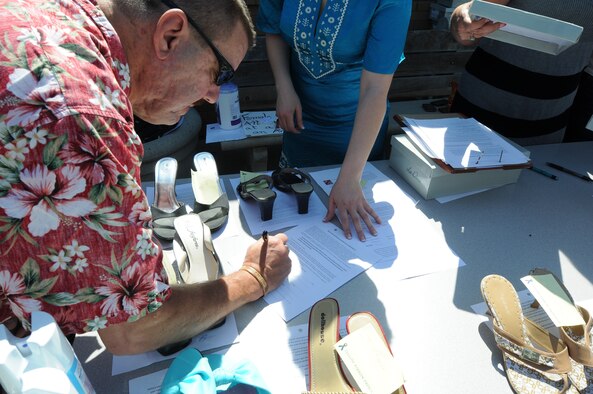 Col. Kevin Dawkins, Idaho National Guard Human Resource Officer, signs up for the Walk a Mile in Her Shoes event April 20 at Gowen Field, Boise, Idaho. The event was held in recognition of Sexual Assault Awareness month.