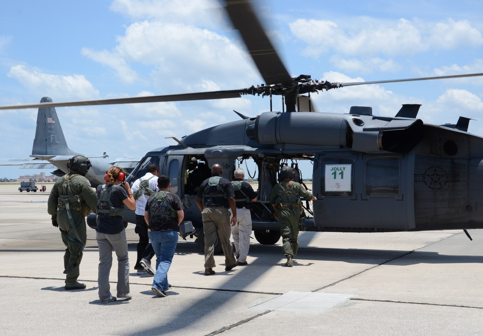 Reserve Airmen from the 920th Rescue Wing prepare flight equipment for spouses and employers of Reservists about to board an HH-60 Pave Hawk helicopter over to fly Florida’s Atlantic Coast. The flight was part of Family Day at Patrick Air Force Base, Fla. (U.S. Air Force photo/Staff Sgt. Anna-Marie Wyant)
