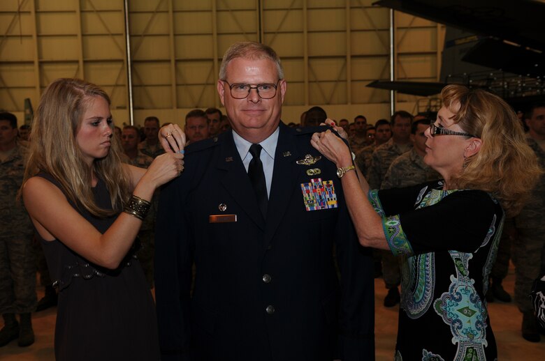 Charlotte, N.C.  -- Col Marshall Collins new rank is pinned by his wife, Janie (left), and daughter Kelsey. (U.S. Air Force photo by Tech. Sgt. Brian E. Christiansen)