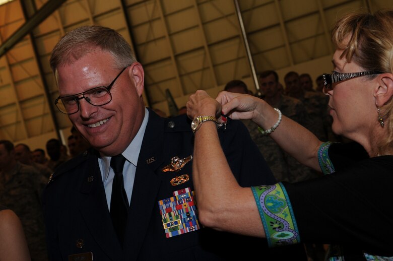 Charlotte, N.C.  -- Janie Marsall pins rank on her husband, Col Marshall Collins. (U.S. Air Force photo by Tech. Sgt. Brian E. Christiansen)