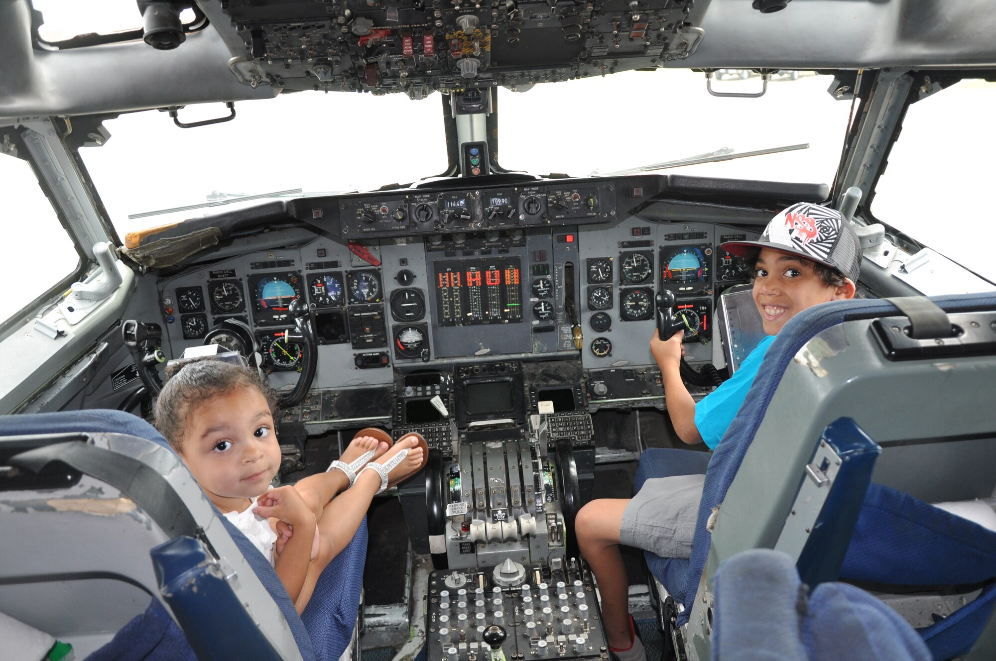 Natalie and Christopher Stanley, children of Staff Sgt. Napolean Stanley, 931st Civil Engineer Squadron, pose in the cockpit of An E-3 Sentry provided by the 970th Airborne Air Control  Squadron during the annual family day, June 3rd. McConnell Airmen and members of their families had the opportunity to spend quality time together during the event, which was sponsored by the Human Resource Development Council. (Air Force photo by Staff Sgt. Carrie M. Peasinger)