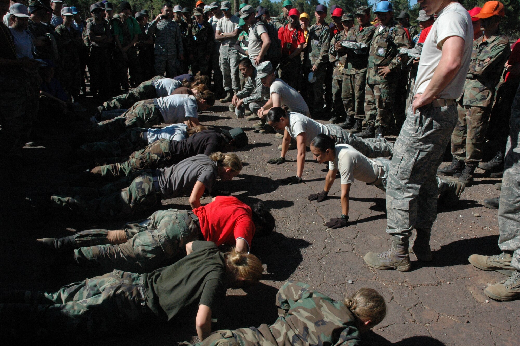 Members of the 161st Air Refueling Wing challenge the female JROTC cadets to a push up competition during a week-long Senior Leadership School May 26 to June 1 at Camp Navajo, Flagstaff, Ariz. SLS is an annual summer camp that provides an opportunity for cadets from different schools to come together and practice their leadership and teamwork skills. (Courtesy photo/released)
