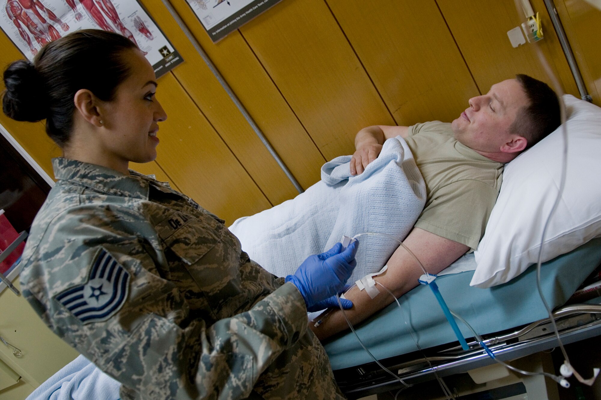 GRISSOM AIR RESERVE BASE, Ind. -- Tech Sgt. Rosalba DeLapaz, 74th Air Refueling Squadron medical element technician, checks on Master Sgt. Mike Morris, 434th Communications Squadron client systems technician, during a recent deployment to Incirlik Air Base, Turkey March 1. The deployers' teamwork and can-do attitude delivered world-class care so that troops wouldn't miss a beat. (U.S. Air Force photo/Senior Airman Jami K. Lancette) 