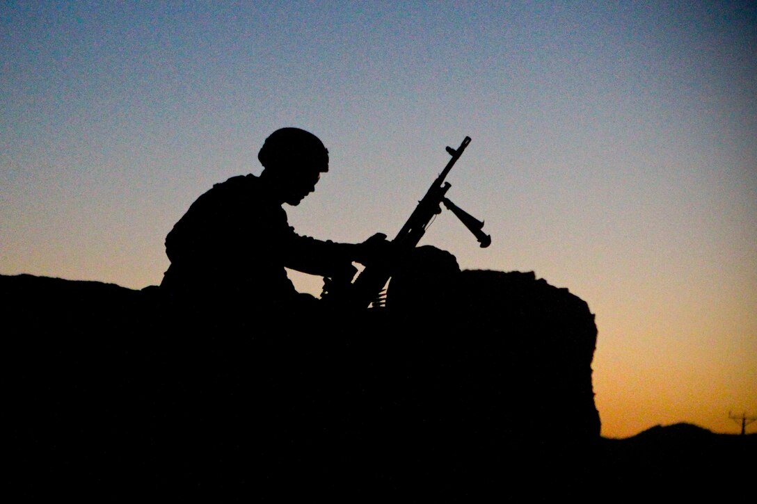 A Marine posts security during an early morning patrol in the town of Zamindawar, June 3, 2012. Marines moved early in the morning to confuse insurgents and avoid the mid-morning heat.