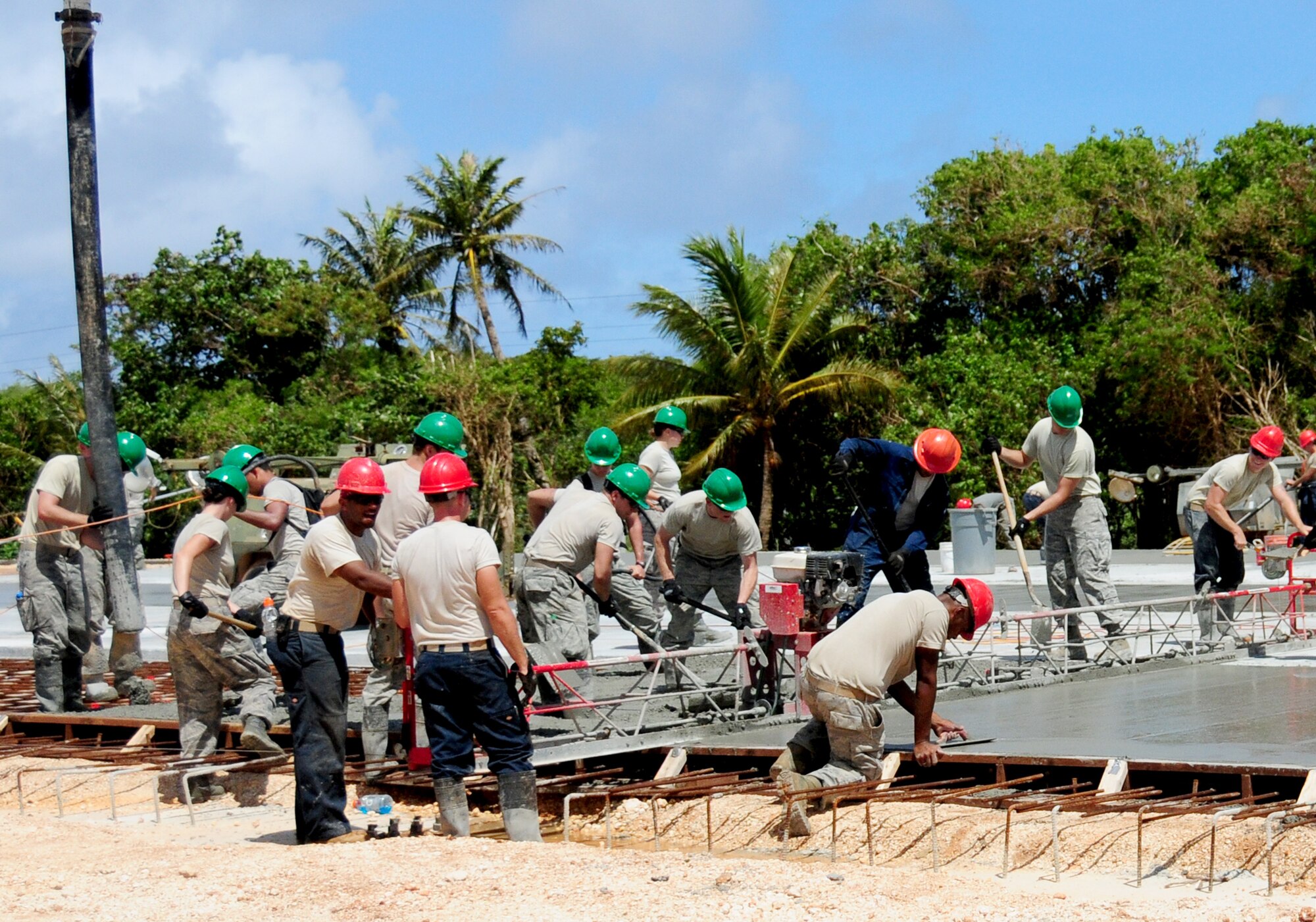 ANDERSEN AIR FORCE BASE, Guam- United States Air Force Academy cadets pour concrete with Airmen from the 554th Red Horse Squadron May 31.  The USAFA cadets are part of the Field Engineering and Readiness Laboratory program for cadets with an engineering major.  (U.S. Air Force photo by Senior Airman Jeffrey Schultze/Released)