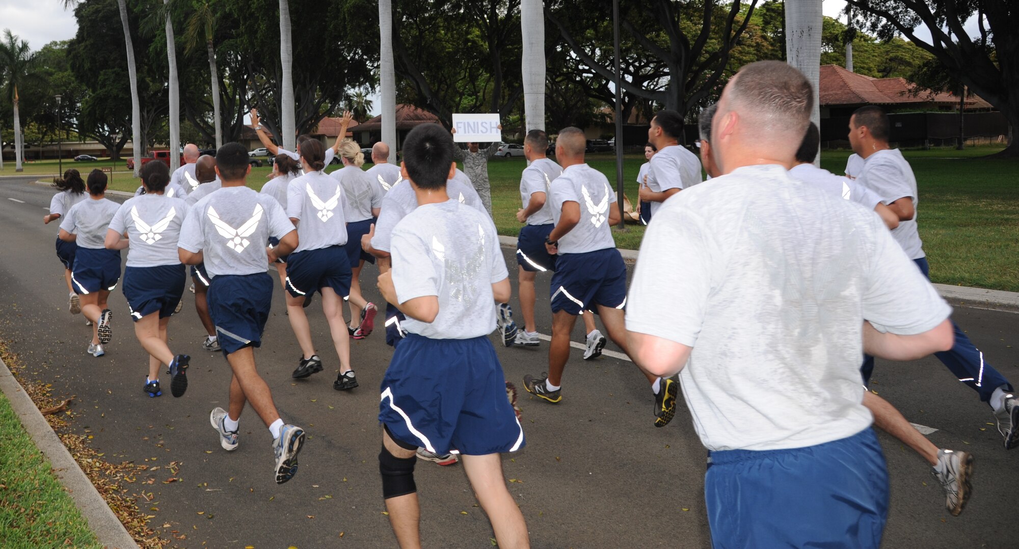 Airmen from Joint Base Pearl Harbor-Hickam, Hawaii, participate in the monthly Warrior Run June 1 at Joint Base Pearl Harbor-Hickam, Hawaii. While the Warrior Run takes place monthly, this run marked the final time Barrett and Col. Joe Dague, 15th Wing vice commander, would participate while occupying those positions. (U.S. Air Force photo by Senior Airman Lauren Main)