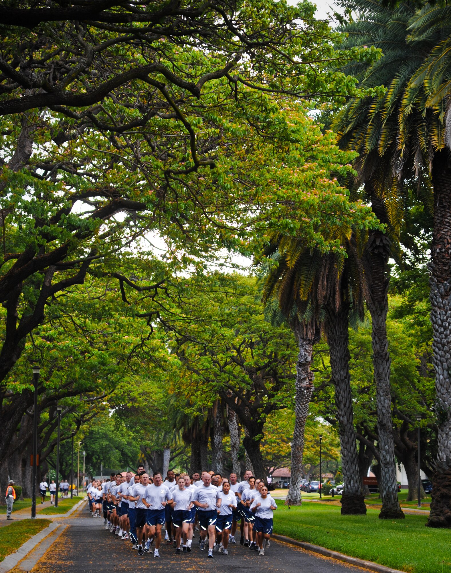 Col. Sam Barrett, 15th Wing commander, leads a formation of 15th Wing Airmen during the monthly Warrior Run June 1 at Joint Base Pearl Harbor-Hickam, Hawaii. While the Warrior Run takes place monthly, this run marked the final time Barrett and Col. Joe Dague, 15th Wing vice commander, would participate while occupying those positions. (U.S. Air Force photo by Senior Airman Lauren Main)