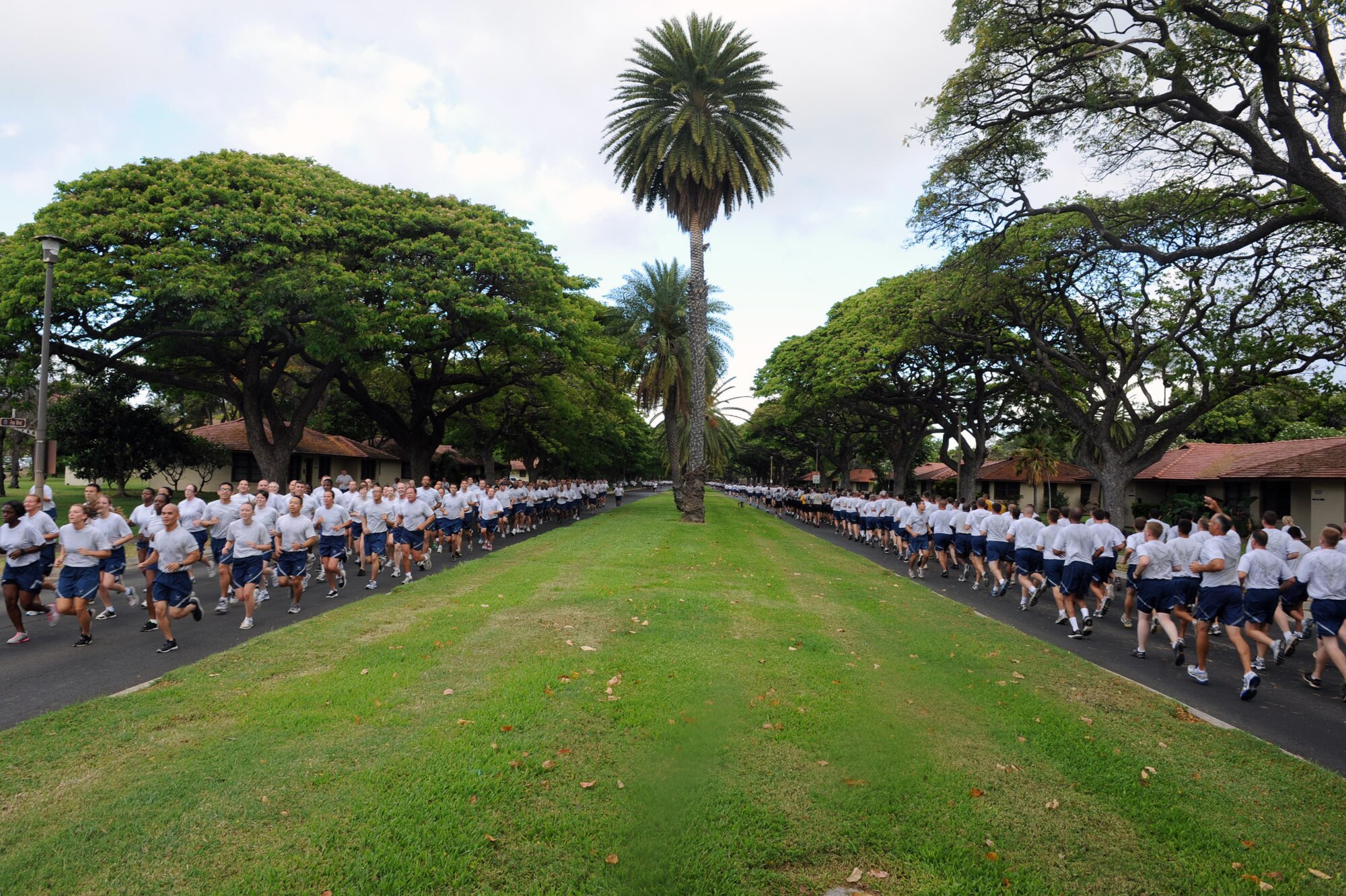 Airmen from Joint Base Pearl Harbor Hickam, Hawaii, run in formation during the Warrior Run June 1. While the Warrior Run takes place monthly, this run marked the final time Col. Sam Barrett, 15th Wing commander, and Col. Joe Dague, 15th Wing vice commander, would participate while occupying those positions. (U.S. Air Force photo by Staff Sgt. Nathan Allen)