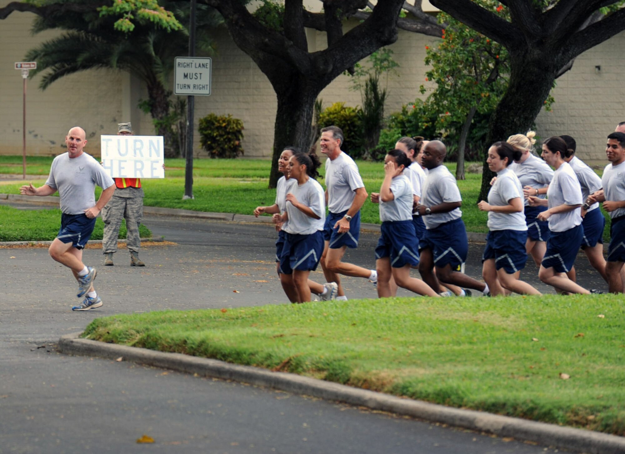 Col. Sam Barrett, 15th Wing commander, leads a formation of 15th Wing Airmen during the monthly Warrior Run June 1 at Joint Base Pearl Harbor Hickam, Hawaii. While the Warrior Run takes place monthly, this run marked the final time Barrett and Col. Joe Dague, 15th Wing vice commander, would participate while occupying those positions. (U.S. Air Force photo by Staff Sgt. Nathan Allen)